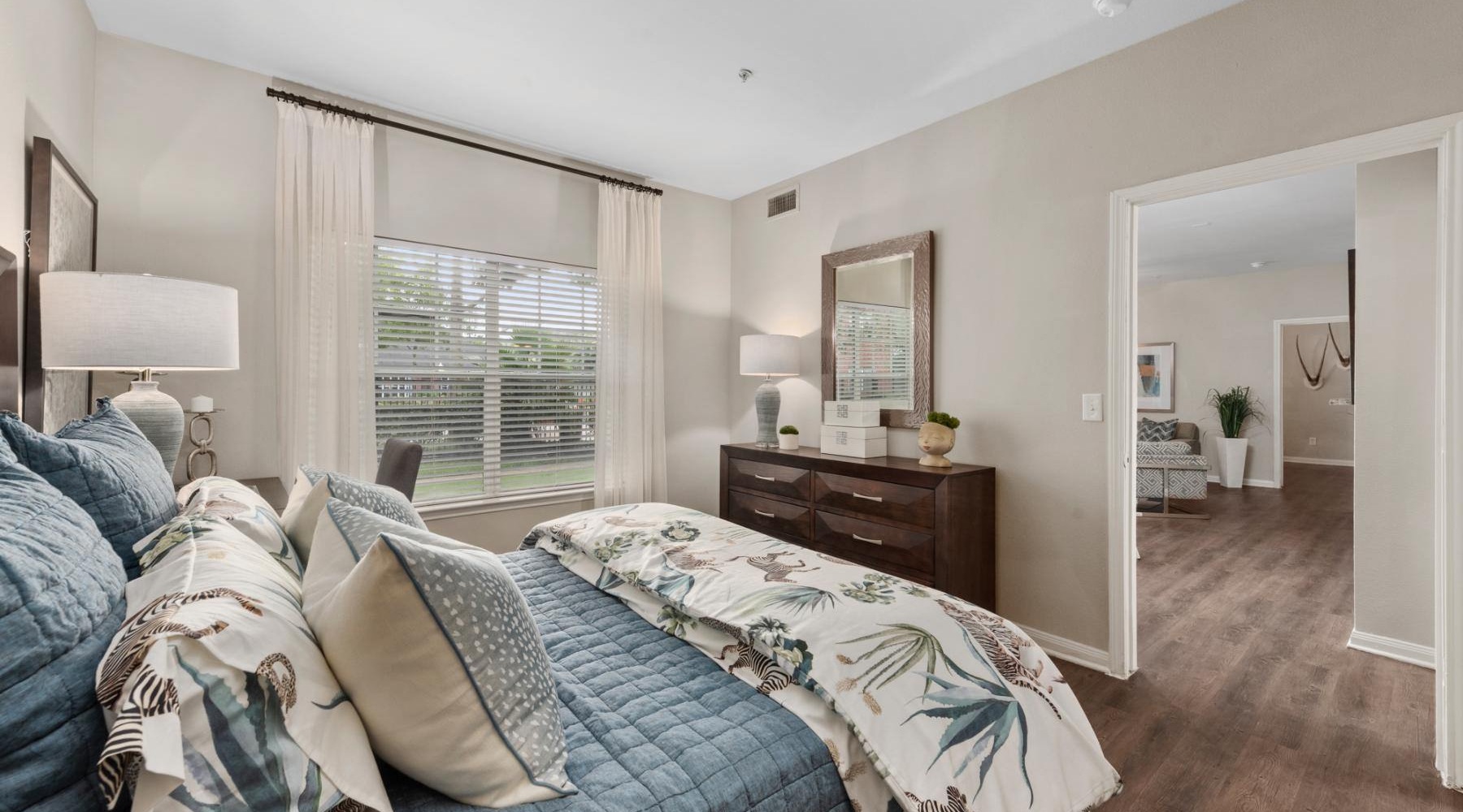 a bedroom with a bed and a dresser