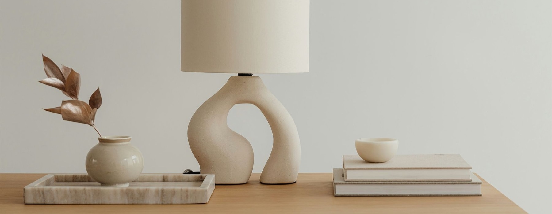 a lamp, stack of books, and decor